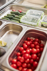 Containers with delicious fresh vegetables in cafe or pizzeria