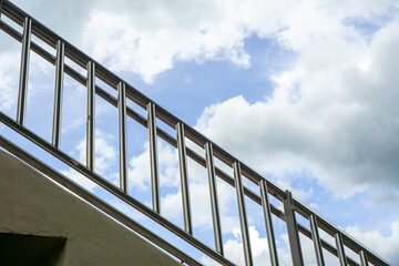 The balustrades are made of stainless steel with sky in the background.