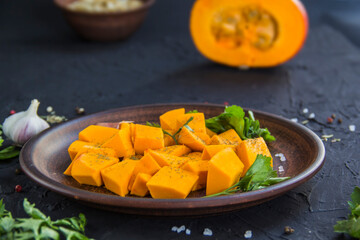 Beautifully chopped pumpkin salad, herbs, and ingredients for the dish. Creative atmospheric decoration