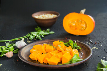 Beautifully chopped pumpkin salad, herbs, and ingredients for the dish. Creative atmospheric decoration