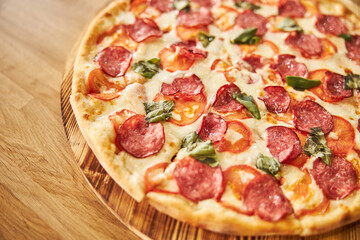 Delicious freshly baked pizza on wooden board