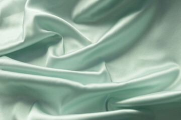 Smooth elegant green silk with soft folds can be used as background