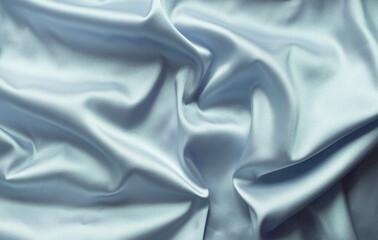 Smooth elegant blue silk with soft folds can be used as background