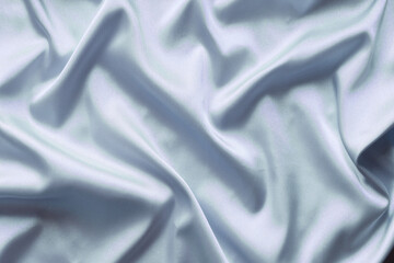 Smooth elegant blue silk with soft folds can be used as background