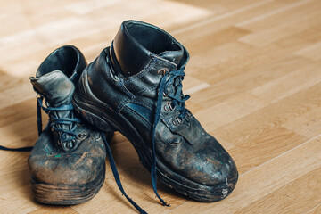 Old worn-out workman's shoes. Shoes that require repair or replacement