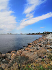 seashore with a stone embankment. The coast of the Black Sea. Embankment alley for walks.