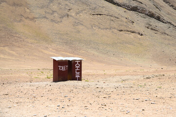 Outside toilet set on sand mountain beside the rural road in Ladakh India
