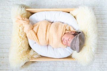 Newborn baby in costume sleeping in baby case