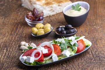 Fototapeta na wymiar olives and hummus on dark wood