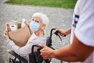 Curious lady looking at the person helping her during the pandemic