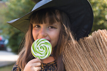 witch eating a candy lollipop, halloween party