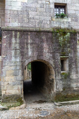 Fototapeta na wymiar Detail of entrance to alley in a medieval stone house in Santillana del Mar, Spain, October 1, 2020