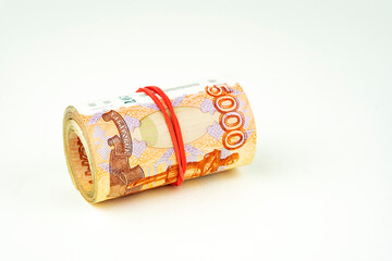 a roll of five-thousand-dollar bills on a white background