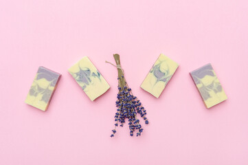 Natural handmade soap with dried lavender and essential oil on pink background. Zero waste concept