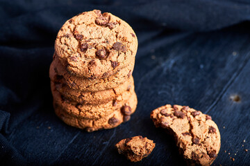 homemade chocolate chip cookies on a dark rustic wood background