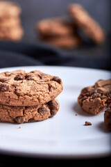 homemade chocolate chip cookies on a dark rustic wood background