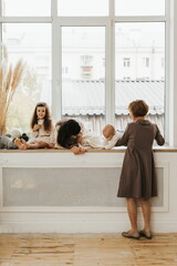 Portrait of a beautiful grandmother and her three grandchildren. Woman, teen girl, child girl and...