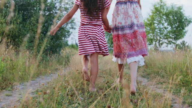 Two little girls walking on rural road