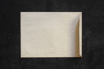 Yellow old paper envelopes on black background, flat lay