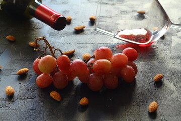 glass of red wine on the table. with fresh grapes.
