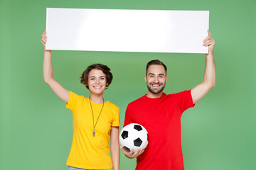 Smiling young couple friends sport family woman man football fans in t-shirts cheer up support...