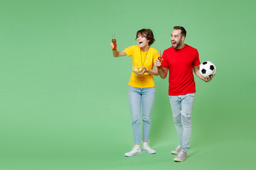 Full length amazed young couple friends sport family woman man football fans in t-shirts cheer up...