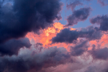 Dramatic and cloudy sky in a purple, blue and orange colors background