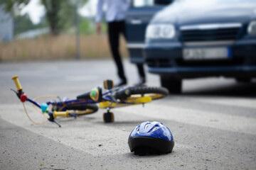 Helmet and bike on the steet after accident with car