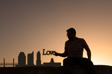 man in front of sacramento city skyline