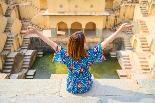 Portrait of young woman traveling in India step-well at Jaipur in Rajasthan state, India