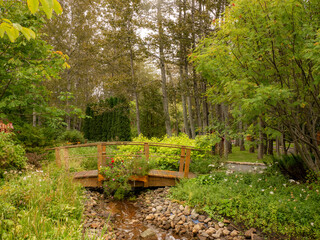 Beautiful small wooden bridge in the flower garden