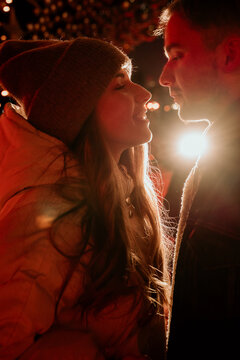 couple, girl and boy ice skating outdoor at rink at night
