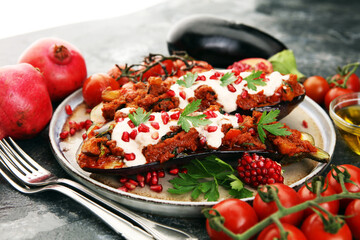 Baked eggplant with tomatoes, garlic and paprika and pomegranate.