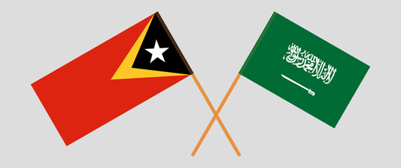 Crossed flags of East Timor and the Kingdom of Saudi Arabia