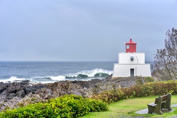 Fototapeta na wymiar Foggy and stormy picture of Amphitrite Point Lighthouse on the coast of Vancouver Island 