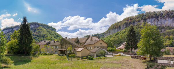 Baume-Les-Messieurs, France - 09 01 2020: View of the village of Baume-les-Messieurs and cliffs behind