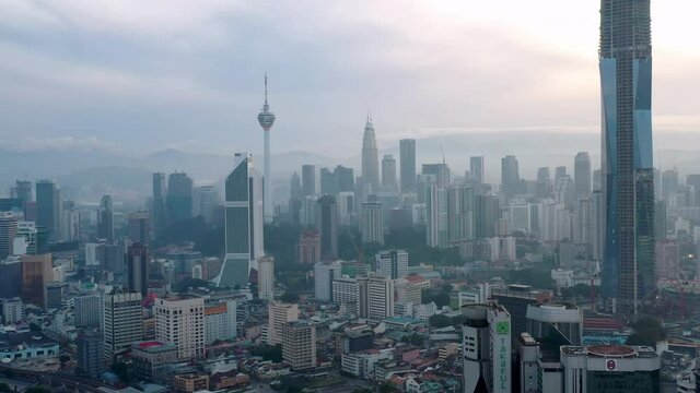 Kuala Lumpur, Malaysia - August 8, 2020: Establishing aerial cinematic drone b-roll shot of sunrise at Kuala Lumpur city skyline. 