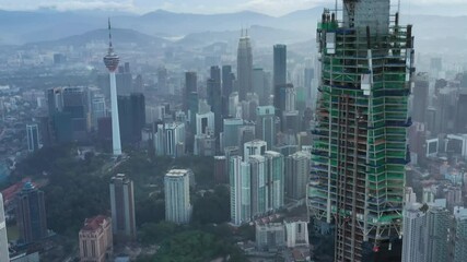 Kuala Lumpur, Malaysia - August 8, 2020: Establishing aerial cinematic drone b-roll shot of sunrise at Kuala Lumpur city skyline. 
