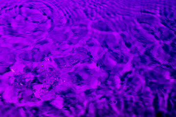 splash of water in lilac light. Abstract wallpaper