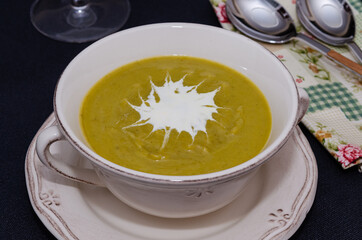 Broccoli cream soup in a bowl served with croutons