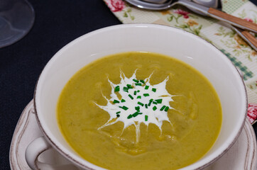 Broccoli cream soup in a bowl served with croutons