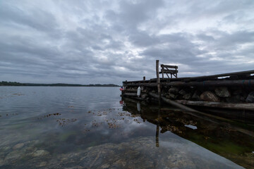 Fototapeta na wymiar Seascape with a old wooden jetty on a overcast day