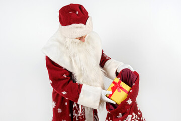 Santa Claus holds gifts in his hands. Isolated on white