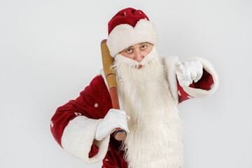 Santa Claus with a baseball bat in his hands. Isolated on white