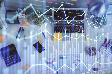 Multi exposure of forex chart drawing over table background with computer. Concept of financial...