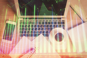 Stock market chart and top view computer on the table background. Double exposure. Concept of financial analysis.