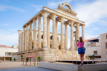 Woman photographing buildings from the Roman era of the city of Merida in Spain