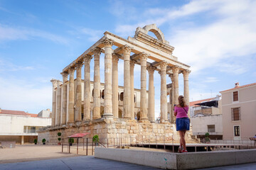 Woman photographing buildings from the Roman era of the city of Merida in Spain