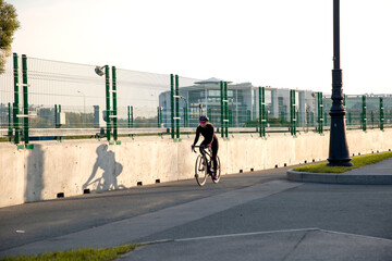 Fototapeta premium Morning cycling workout in the city. Outdoor cycling.