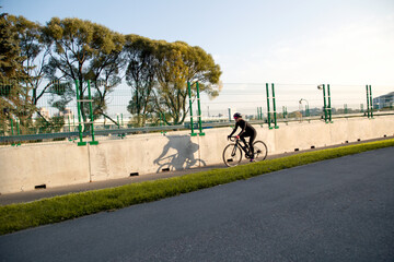 Naklejka premium Morning cycling workout in the city. Outdoor cycling.